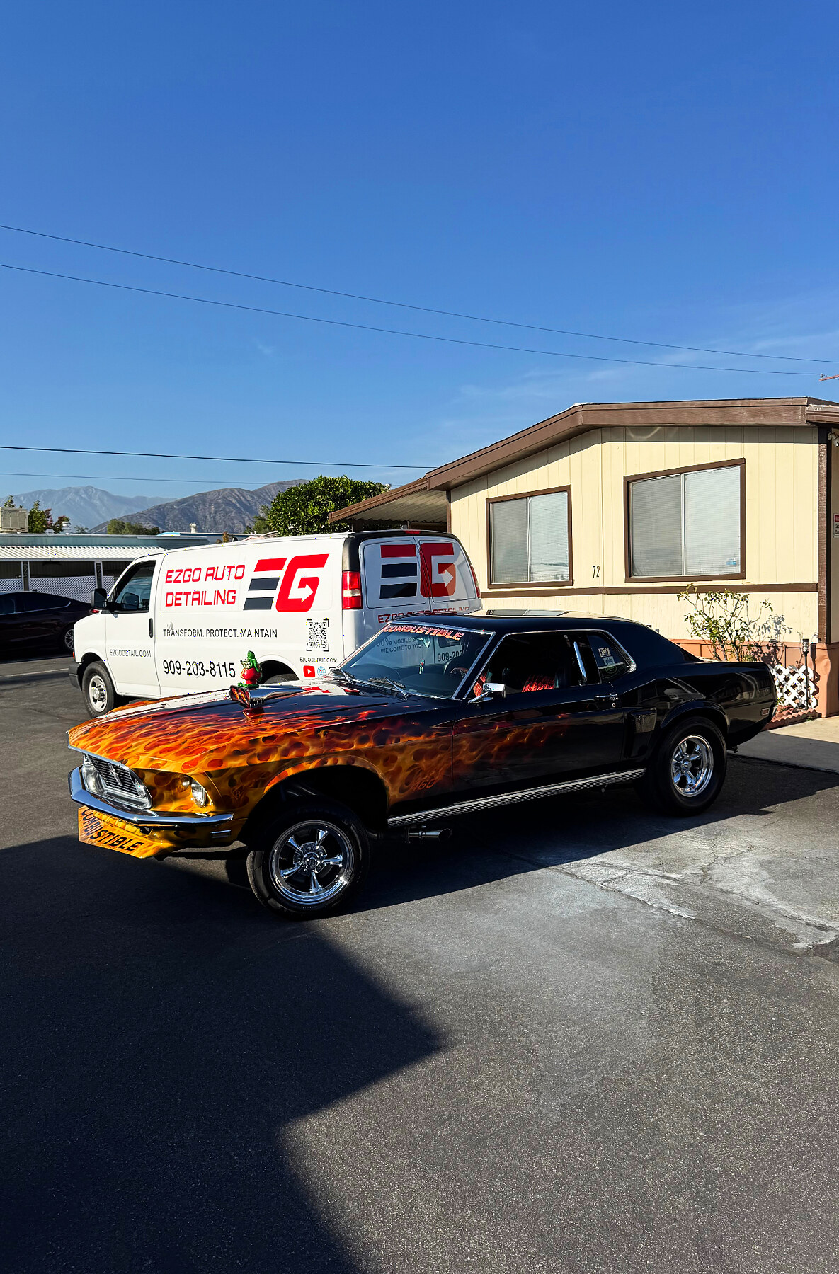 EZGO Auto Detailing technician polishing a car with the mobile van